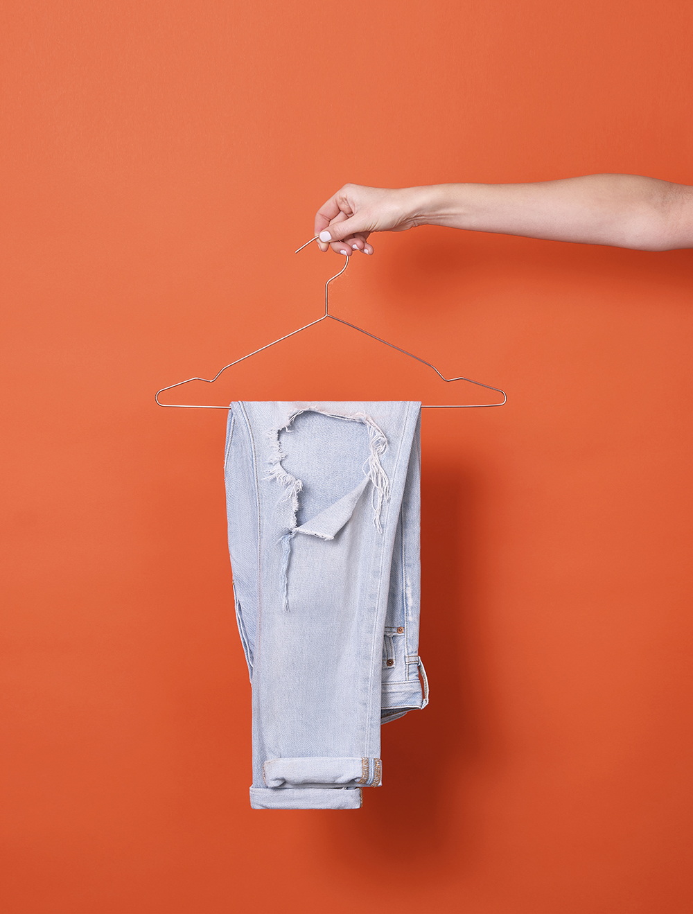 Fashion studio shot with jeans on hanger